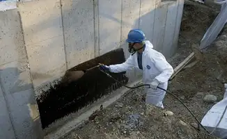 Professional waterproofing the exterior walls of the basement in Houston, TX