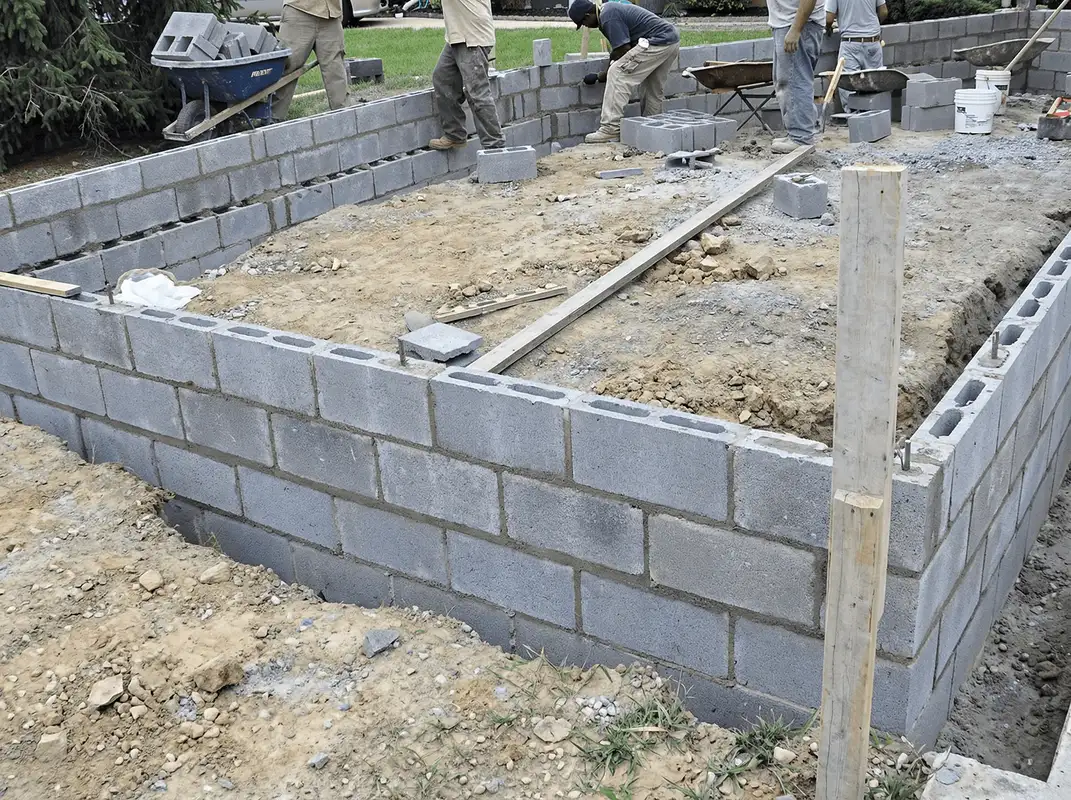 Professionals building a foundation with blocks in Houston, TX